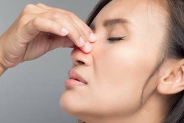 The asian woman hurts her nose because she has cold. The asian woman hurts her nose because she has cold.